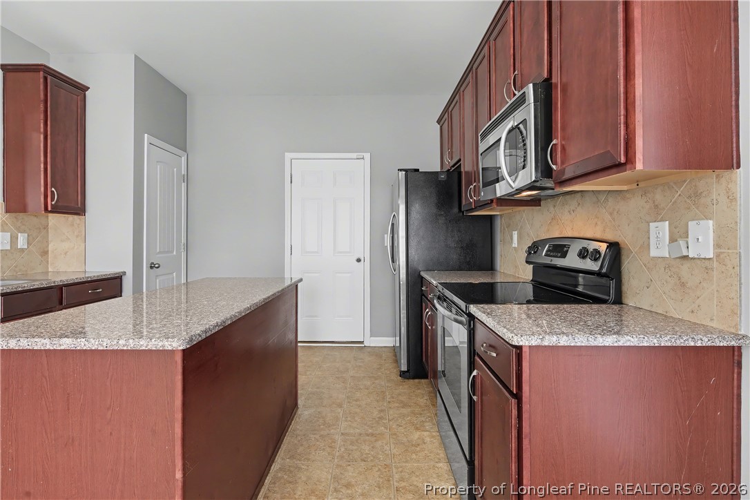 61 Bicentennial Way Cameron, NC 28326 - Photo 18 of 49 a kitchen with stainless steel appliances granite countertop a sink stove and cabinets
