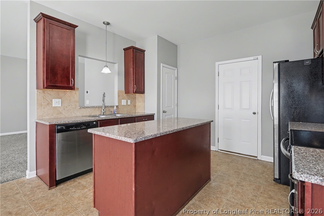 61 Bicentennial Way Cameron, NC 28326 - Photo 19 of 49 a kitchen with stainless steel appliances granite countertop a sink and a refrigerator