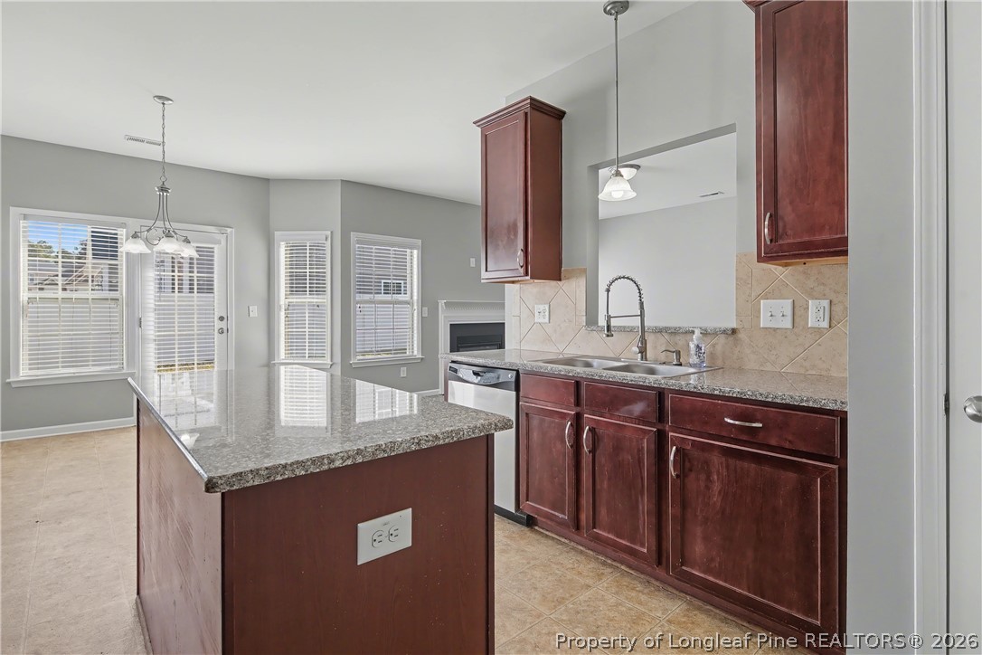 61 Bicentennial Way Cameron, NC 28326 - Photo 24 of 49 a kitchen with stainless steel appliances granite countertop a sink a stove and a wooden cabinets