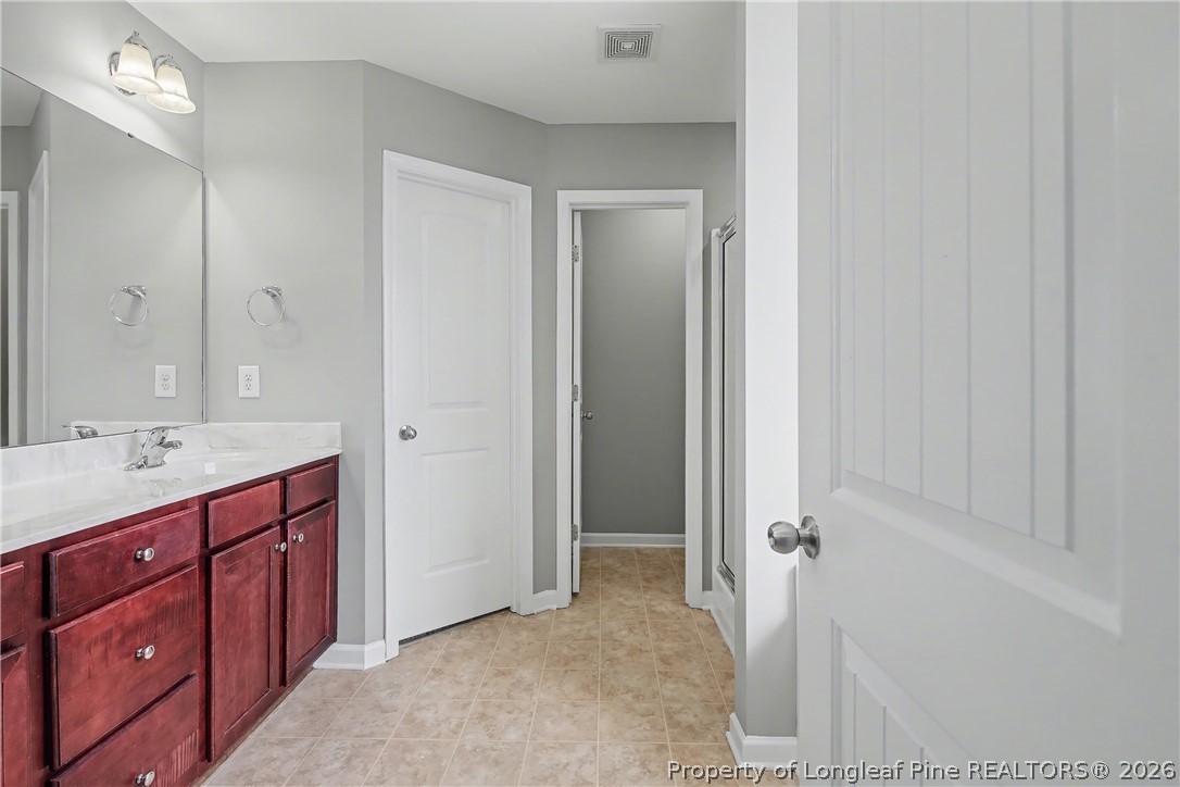 61 Bicentennial Way Cameron, NC 28326 - Photo 29 of 49 a bathroom with a sink and a mirror