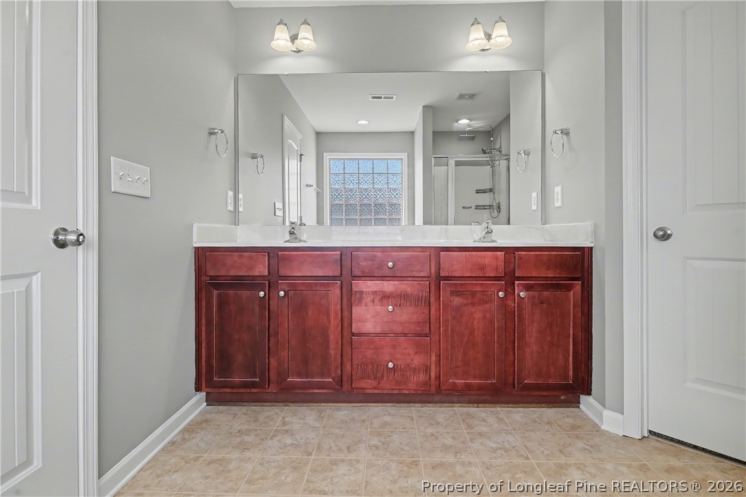 61 Bicentennial Way Cameron, NC 28326 - Photo 30 of 49 a bathroom with a sink and a mirror