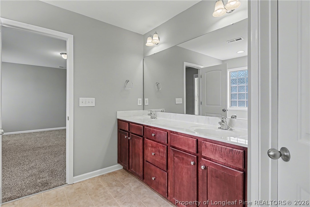 61 Bicentennial Way Cameron, NC 28326 - Photo 31 of 49 a spacious bathroom with a granite countertop sink mirror and double