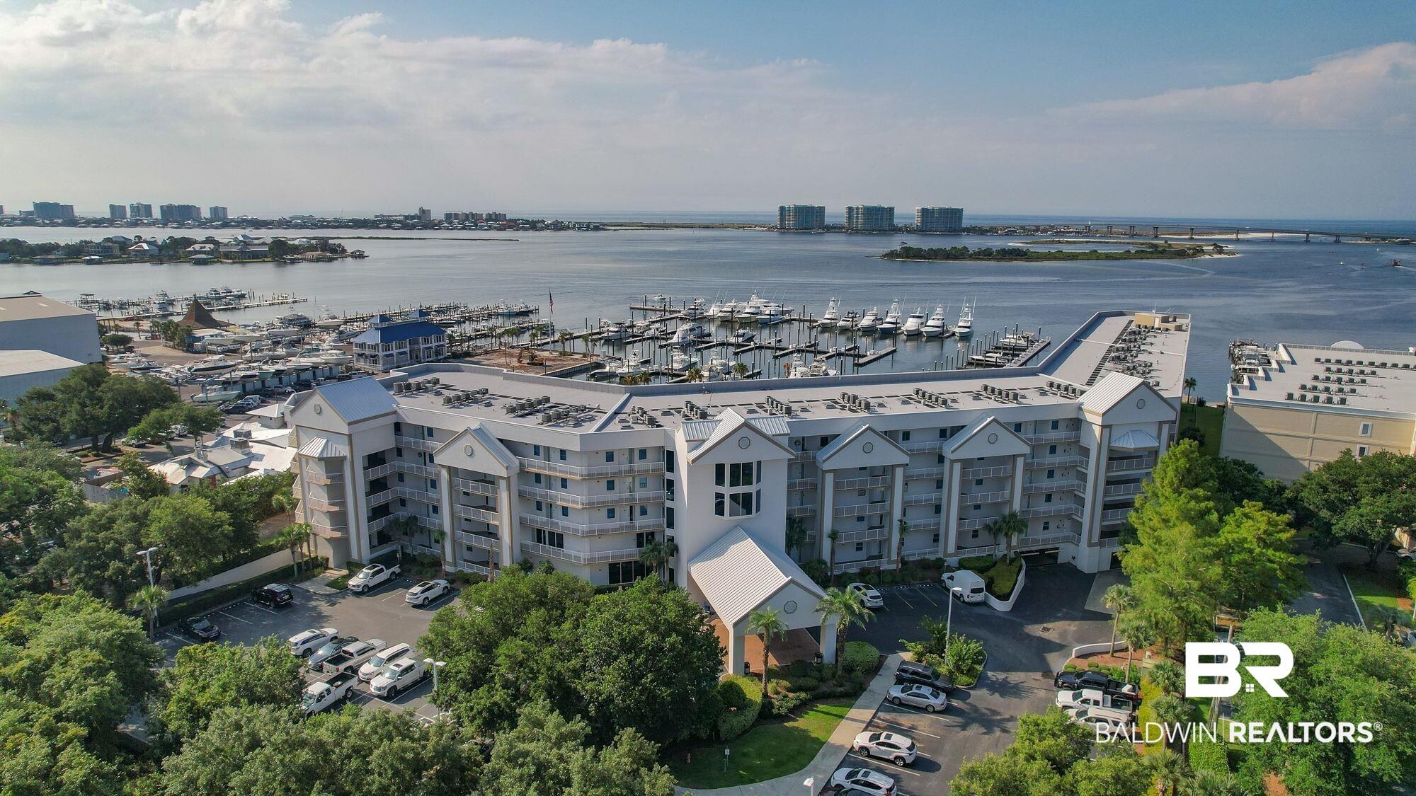 27800 Canal Road, Unit 313 Orange Beach, AL 36561 - Photo 1 of 23 Drone / aerial view of a marina and apartment complex