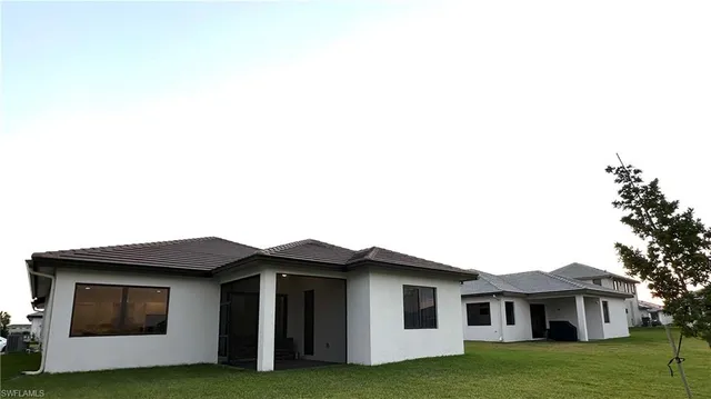 a front view of a house with a garden and yard