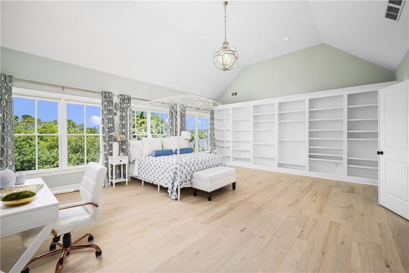 13980 Haystack Lane Milton, GA 30004 - Photo 35 of 83 a bedroom with a large bed and a chandelier