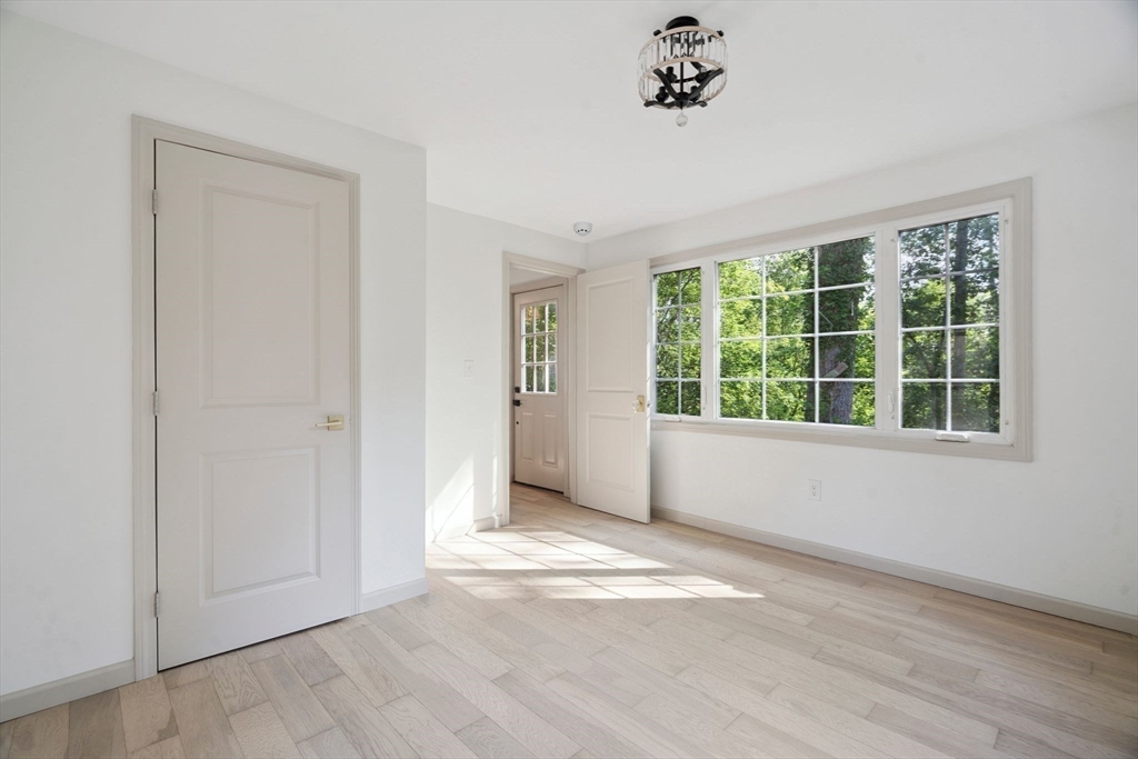 18 Chestnut Hill Road Millville, MA 01529 - Photo 13 of 26 wooden floor in an empty room with a window