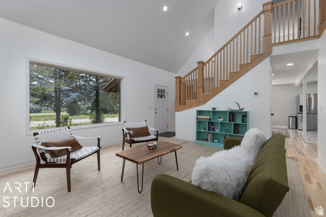 2807 North Ogden Canyon Road Eden, UT 84310 - Photo 16 of 72 Spacious living area featuring high vaulted ceilings, light wood-finish flooring, and a prominent wood staircase with matching railings