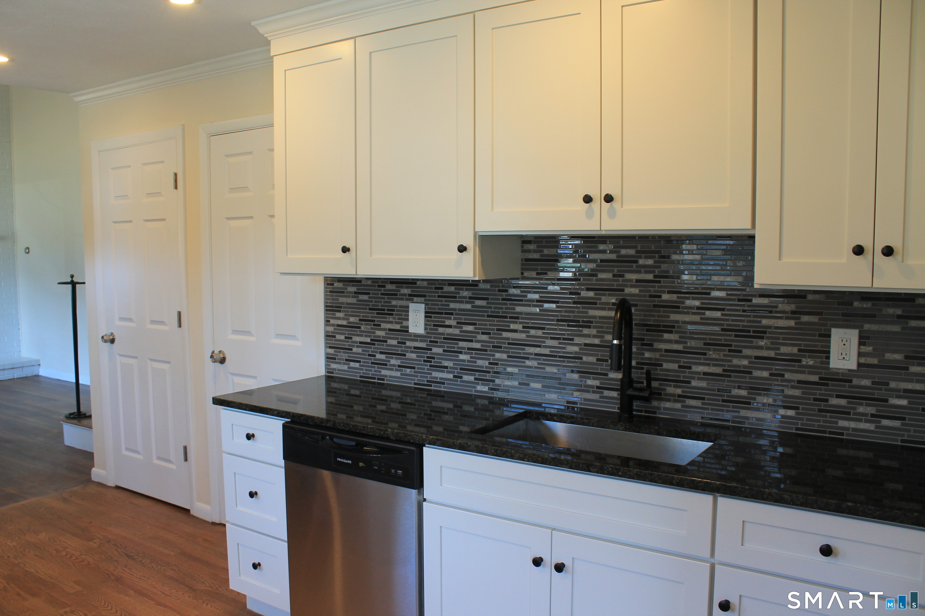 134 Sunset Street Windsor Locks, CT 06096 - Photo 6 of 23 a kitchen with granite countertop white cabinets and black appliances