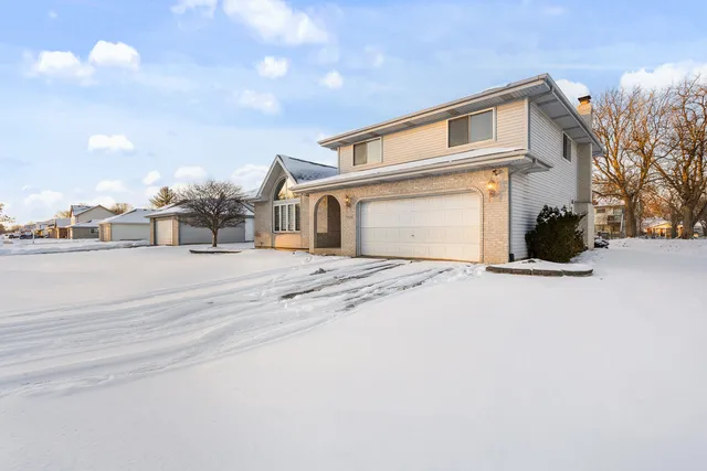 a view of a house with a snow on the road