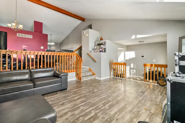 a view of a livingroom with furniture and stairs