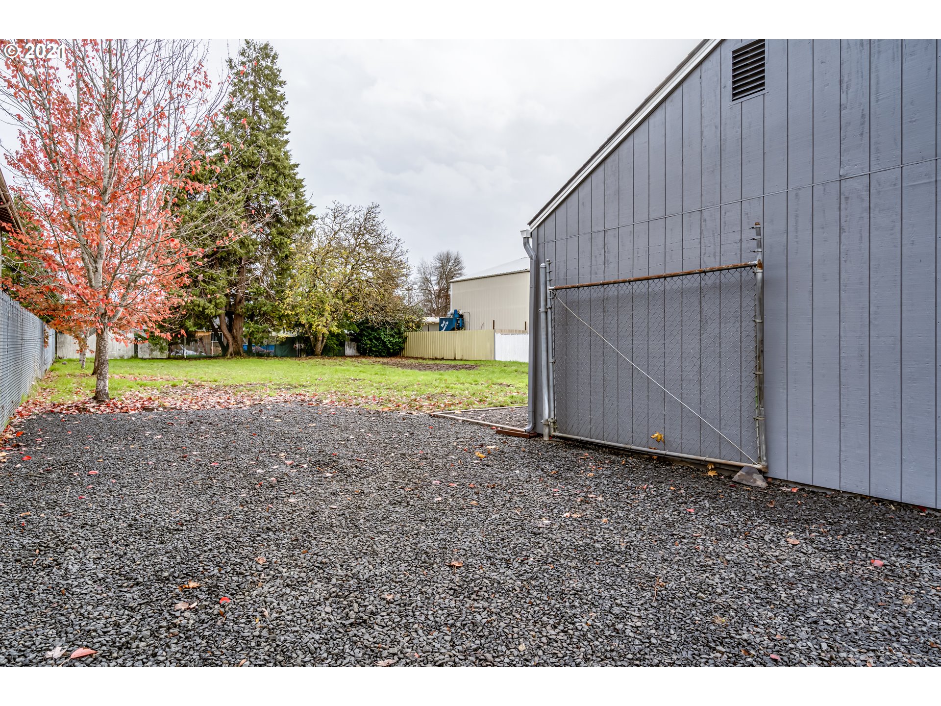 215 39th Street Springfield, OR 97478 - Photo 3 of 27 a view of a backyard with barn and large trees