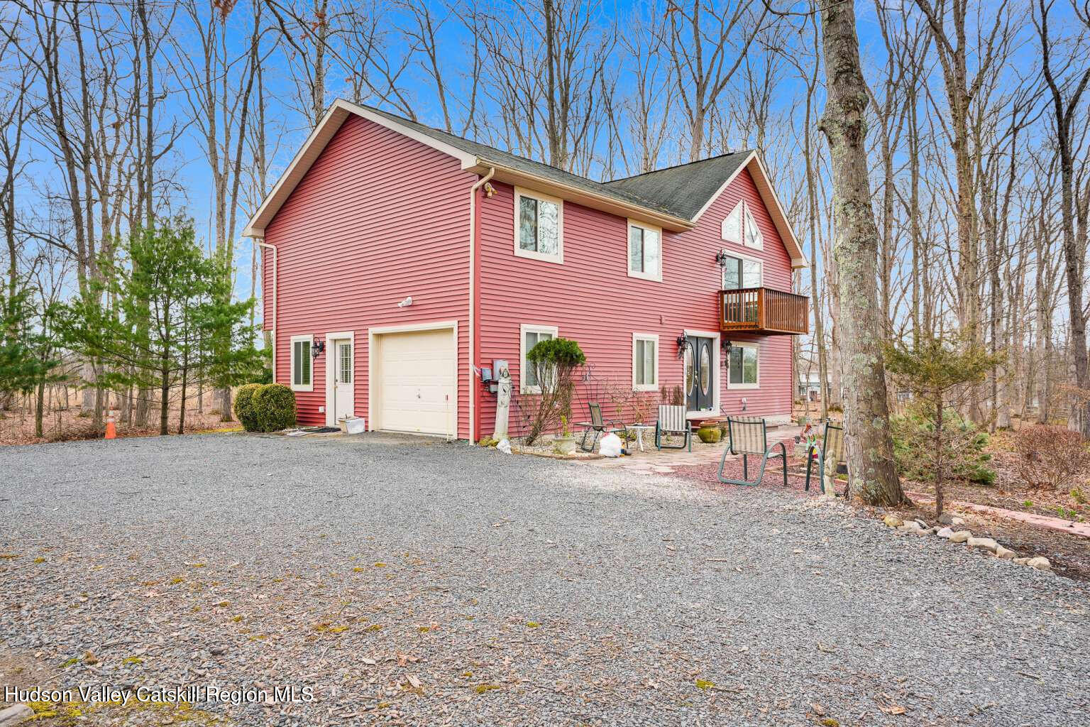 a view of a house with a patio and a yard