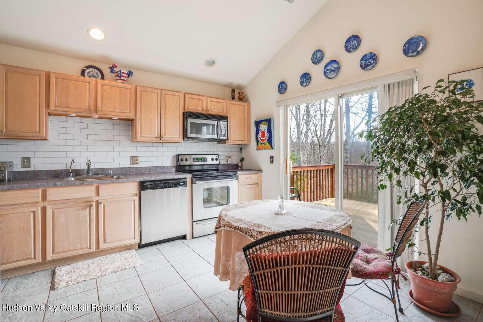 257 Bruynswick Road New Paltz, NY 12561 - Photo 7 of 23 a kitchen with stainless steel appliances granite countertop a sink a stove a microwave a refrigerator and cabinets