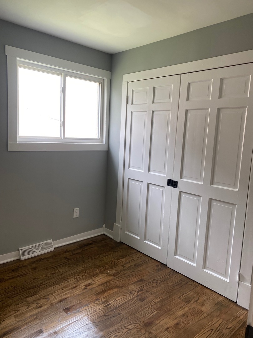 6732 South Peoria Street Chicago, IL 60621 - Photo 11 of 16 a view of an empty room with wooden floor and a window