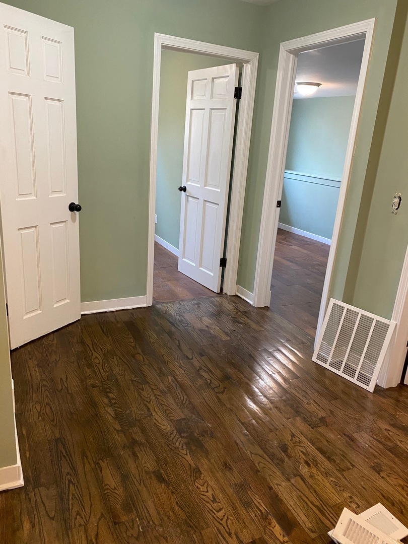 6732 South Peoria Street Chicago, IL 60621 - Photo 12 of 16 wooden floor and bench in a hallway