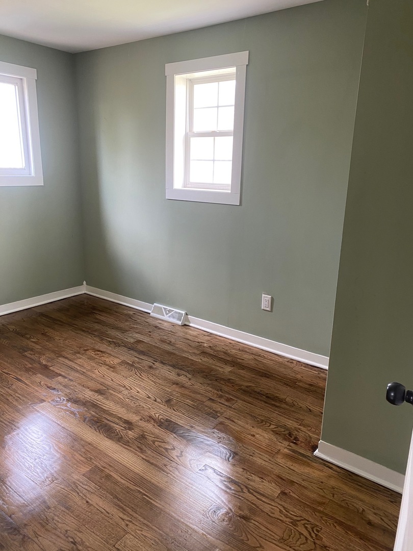 6732 South Peoria Street Chicago, IL 60621 - Photo 13 of 16 a view of a room with wooden floor and windows