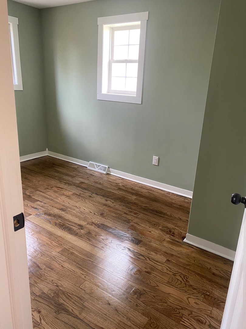6732 South Peoria Street Chicago, IL 60621 - Photo 14 of 16 a view of empty room with wooden floor