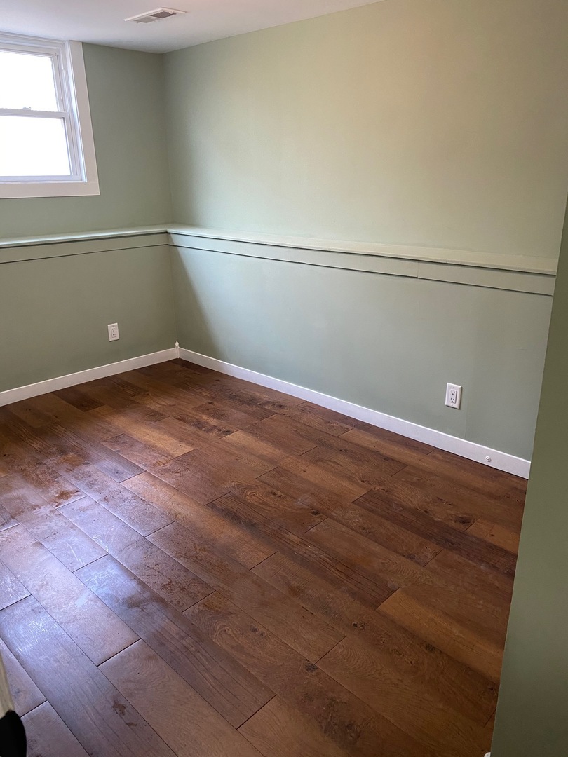 6732 South Peoria Street Chicago, IL 60621 - Photo 15 of 16 a view of a room with wooden floor
