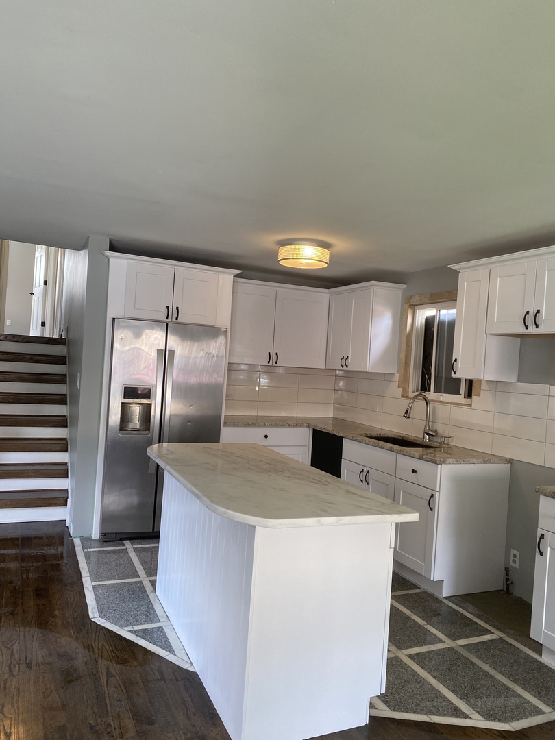 6732 South Peoria Street Chicago, IL 60621 - Photo 3 of 16 a kitchen with stainless steel appliances granite countertop a sink stove and refrigerator