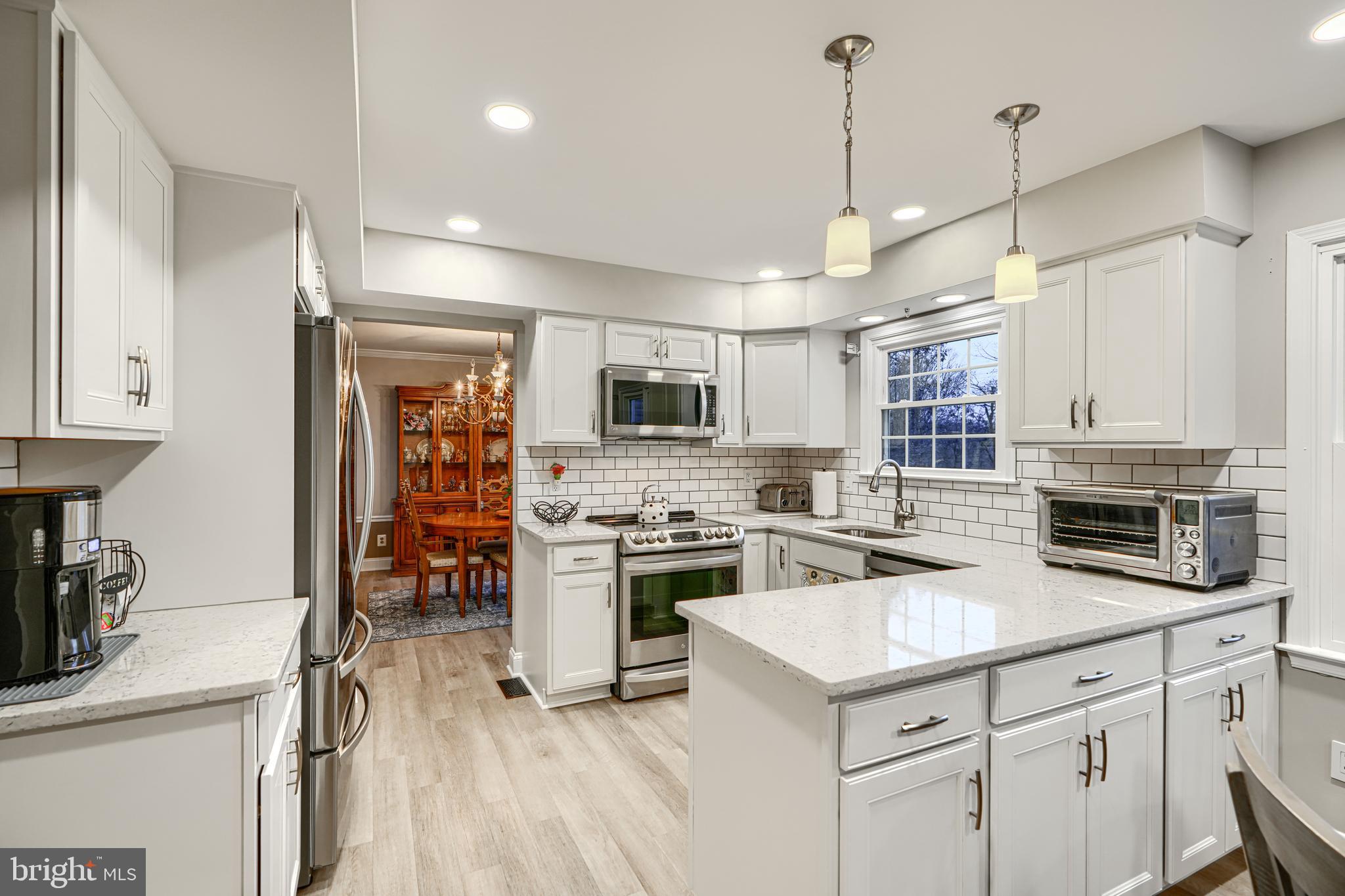 3 Horn Point Court Baltimore, MD 21234 - Photo 23 of 83 a kitchen with stainless steel appliances granite countertop a stove top oven a sink dishwasher and a refrigerator with wooden floor