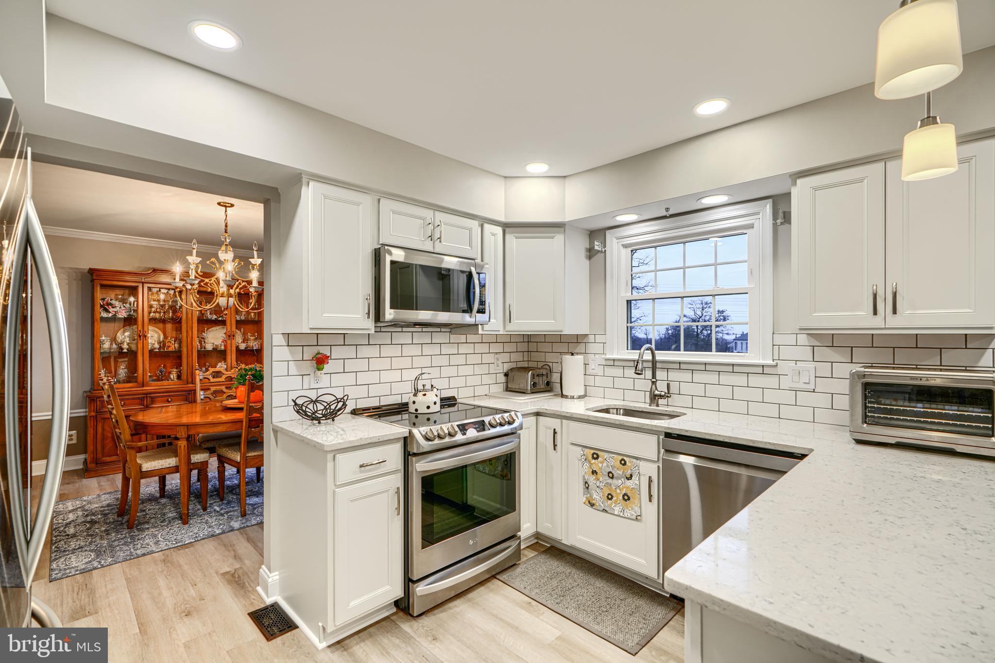 3 Horn Point Court Baltimore, MD 21234 - Photo 26 of 83 a kitchen with stainless steel appliances a stove sink microwave and cabinets