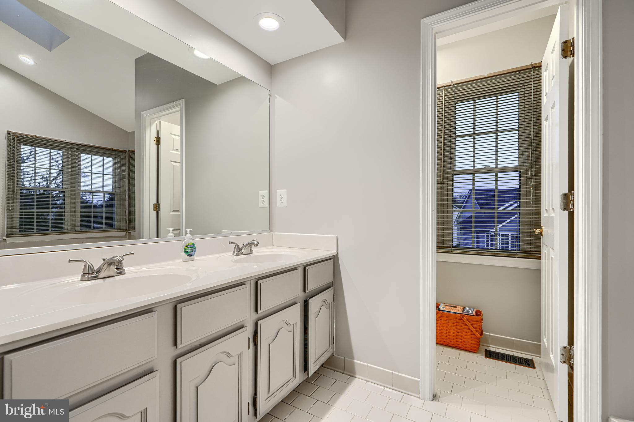 3 Horn Point Court Baltimore, MD 21234 - Photo 43 of 83 a bathroom with a double vanity sink and mirror