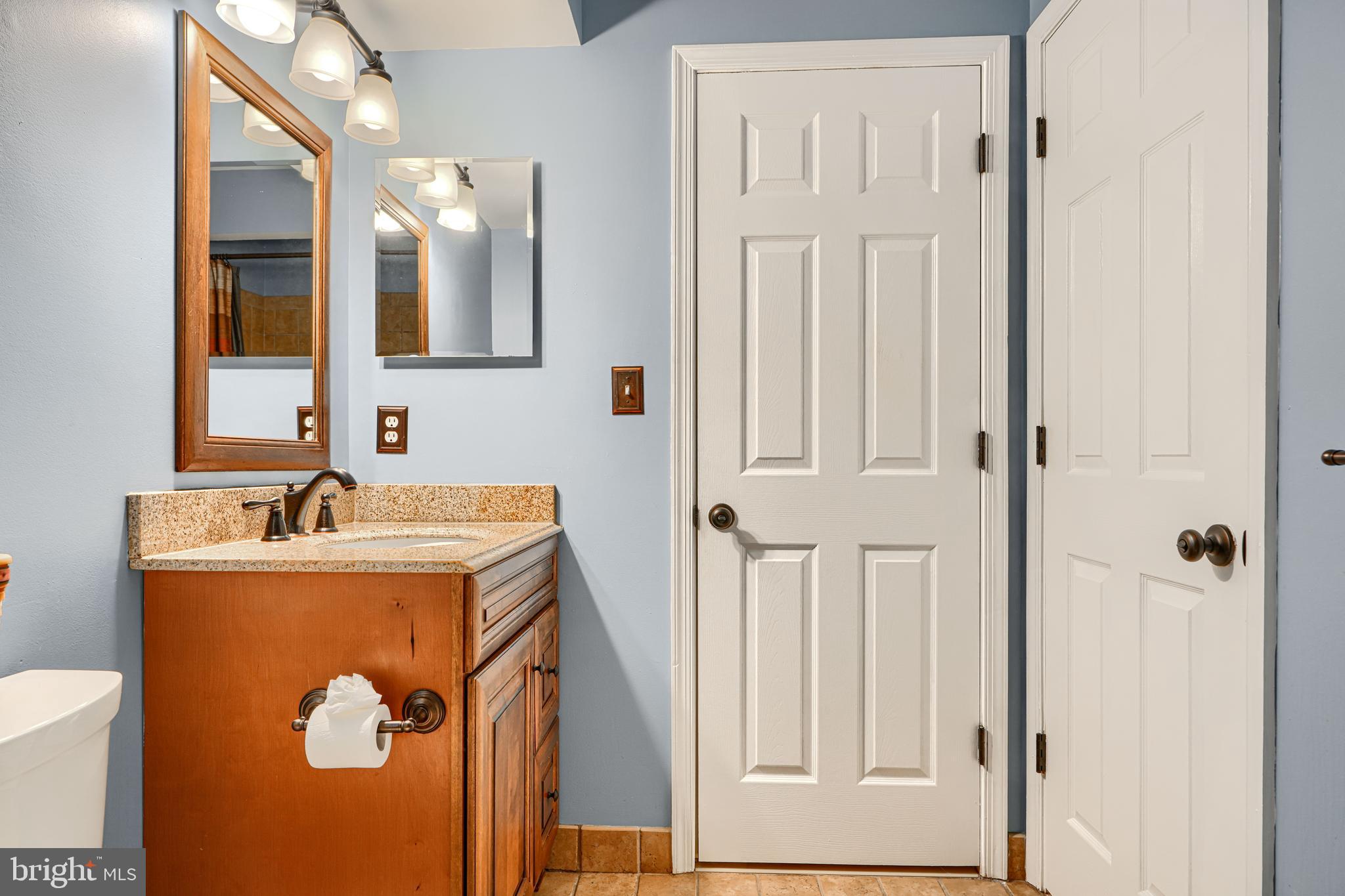 3 Horn Point Court Baltimore, MD 21234 - Photo 56 of 83 a bathroom with a sink and mirror with toilet