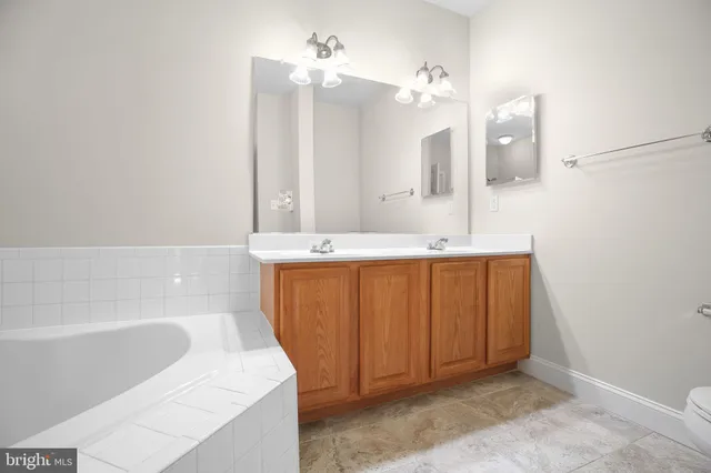 a bathroom with a sink a mirror and a bathtub