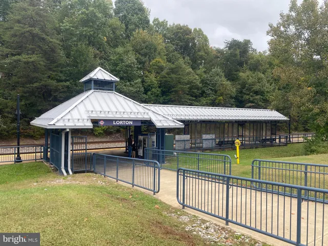 a view of a house with a yard balcony and furniture