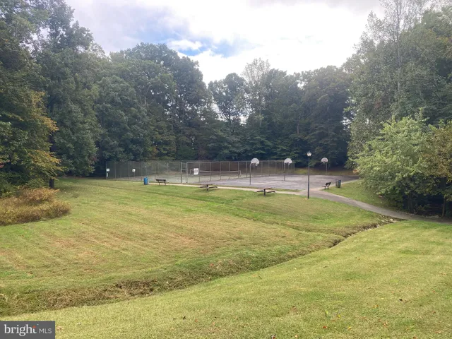 a view of a swimming pool with an outdoor seating and a yard