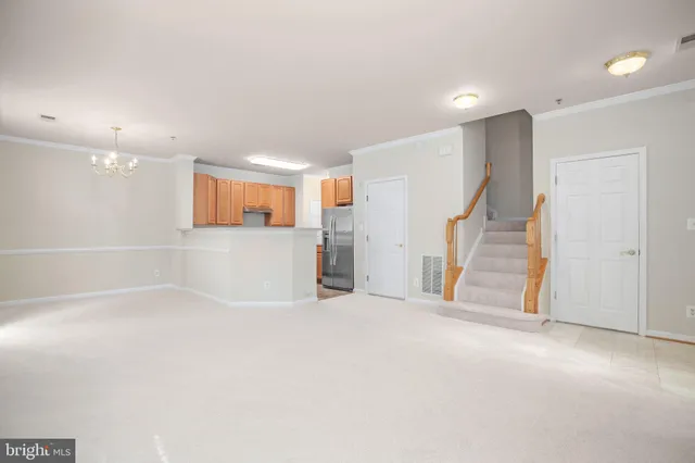 an empty room with a cabinet and mirrors