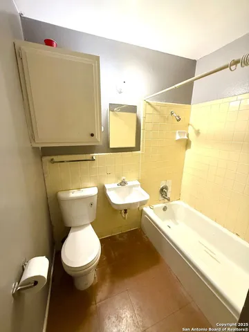a bathroom with a toilet sink and bathtub