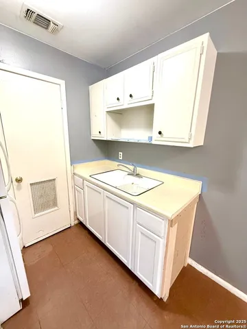 a utility room with cabinets washer and dryer