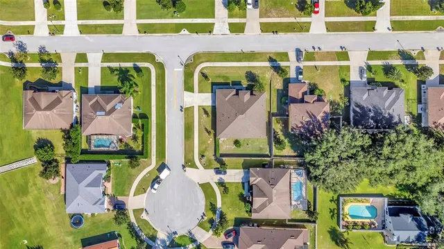 a view of a house with swimming pool and sitting area