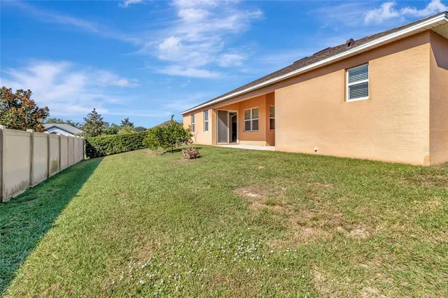 an aerial view of residential houses with outdoor space and swimming pool