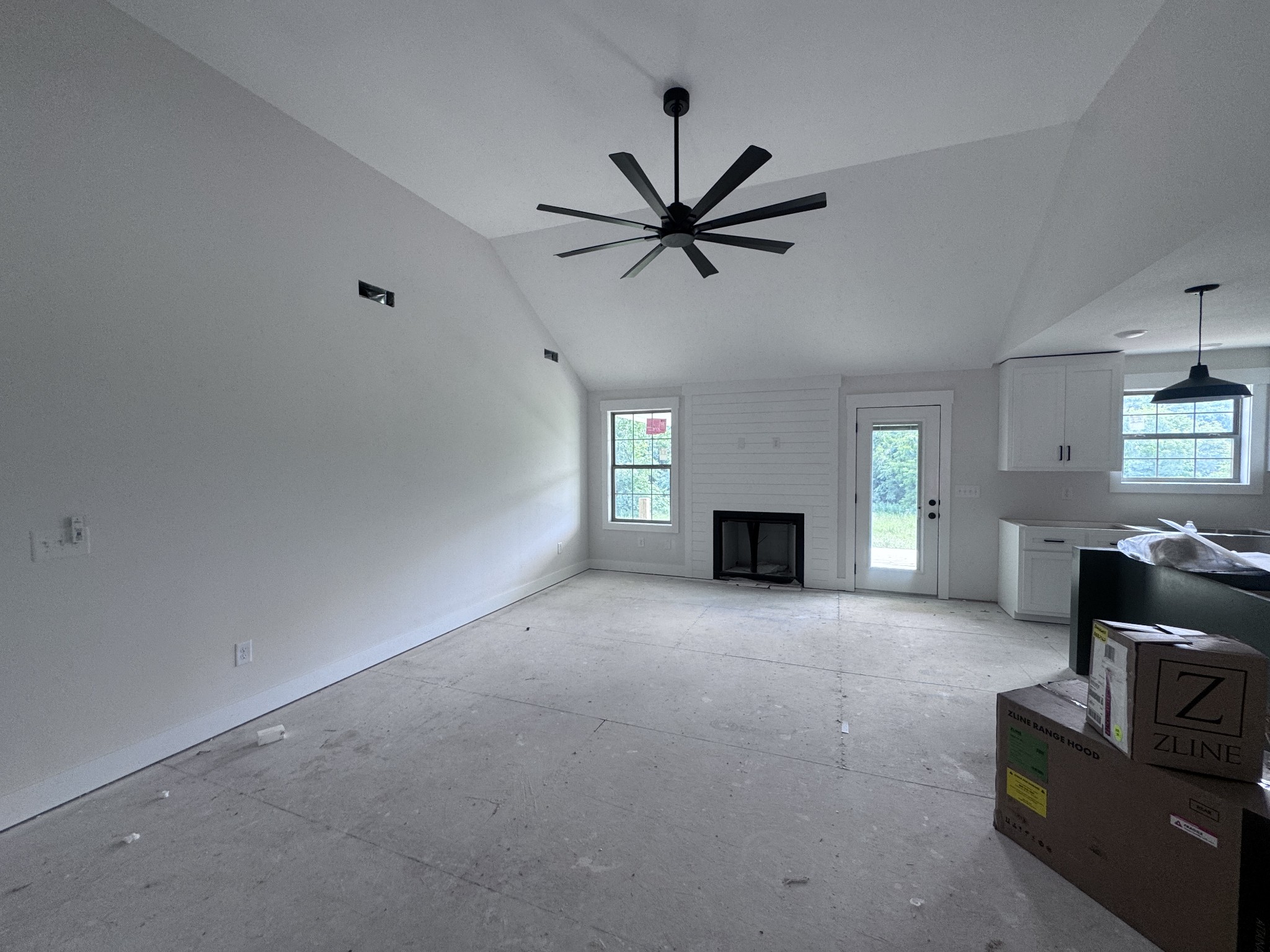 1830 McWhorter Road Cunningham, TN 37052 - Photo 30 of 46 a view of a livingroom with a fireplace a ceiling fan and a window