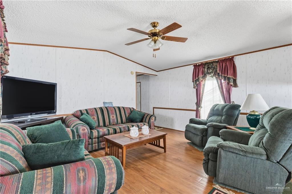 215 South Valley View Road, Unit 15&16 Donna, TX 78537 - Photo 4 of 13 a living room with furniture and a flat screen tv