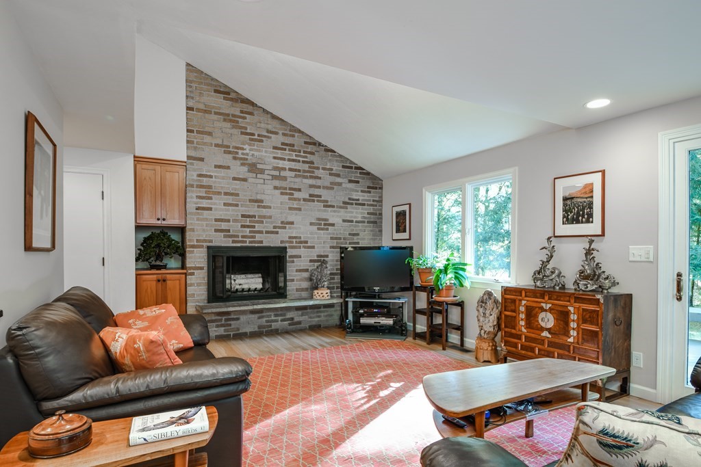 50 Old Orchard Road Sherborn, MA 01770 - Photo 14 of 26 a living room with furniture a fireplace a flat screen tv and a window