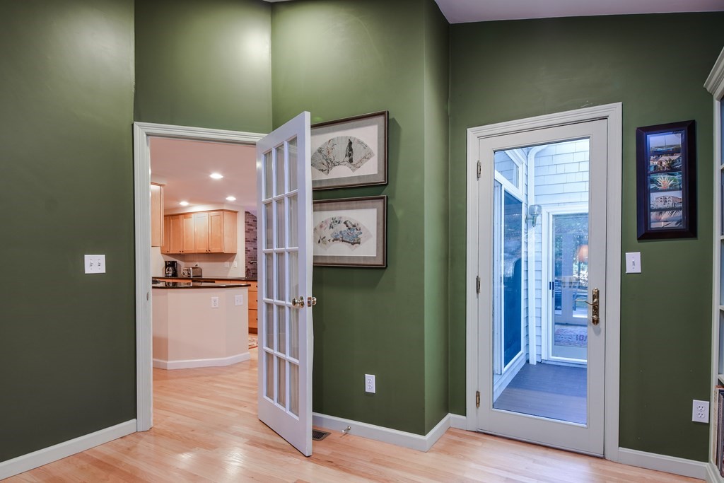 50 Old Orchard Road Sherborn, MA 01770 - Photo 17 of 26 a view of a hallway with wooden floor and a living room