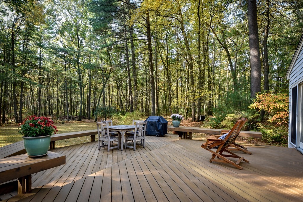 50 Old Orchard Road Sherborn, MA 01770 - Photo 25 of 26 a view of a patio with a dining table and chairs with wooden floor and fence