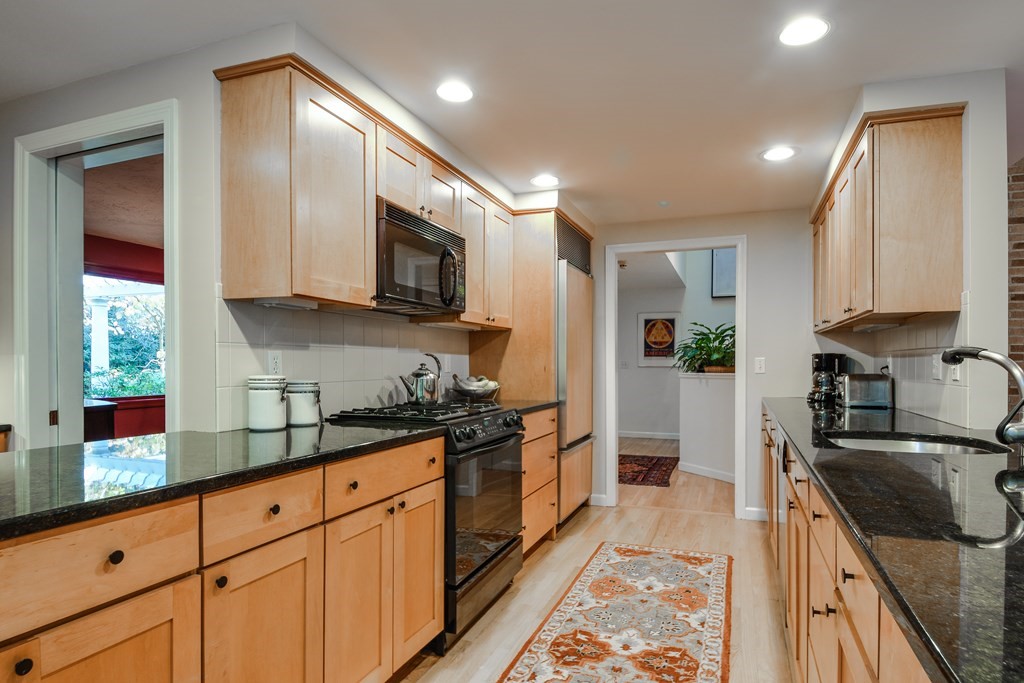 50 Old Orchard Road Sherborn, MA 01770 - Photo 10 of 26 a kitchen with stainless steel appliances granite countertop a sink a stove and a refrigerator