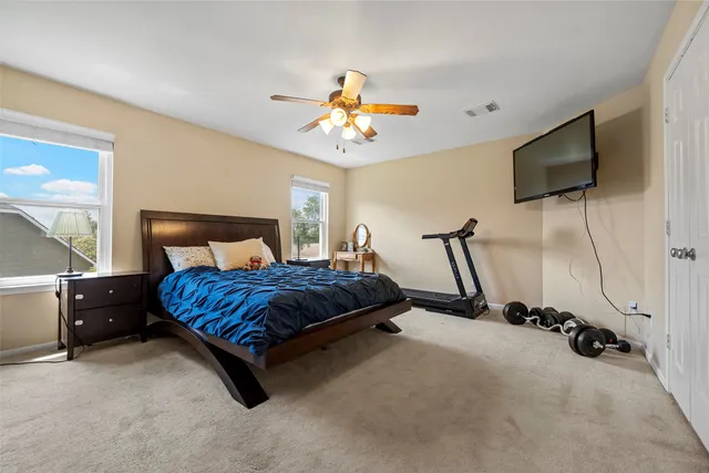 a bedroom with a bed and a flat screen tv