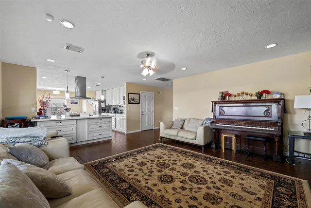 a view of a patio with table and chairs potted plants with wooden floor and fence