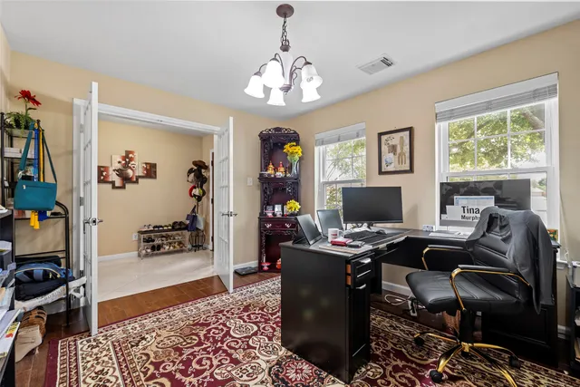 a view of hallway with stairs and wooden floor