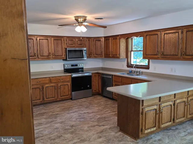 a kitchen with cabinets a sink and a stove