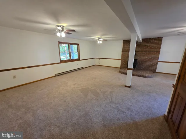 a view of a livingroom with furniture and windows
