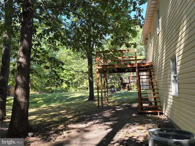a view of a yard with wooden fence
