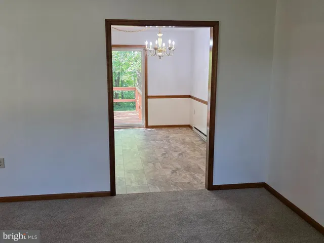 a view of an empty room with a fireplace