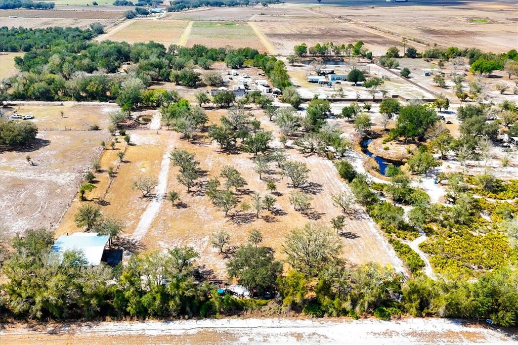 6096 Northwest Cul De Sac Road Arcadia, FL 34266 - Photo 2 of 20 an aerial view of residential houses with outdoor space and trees