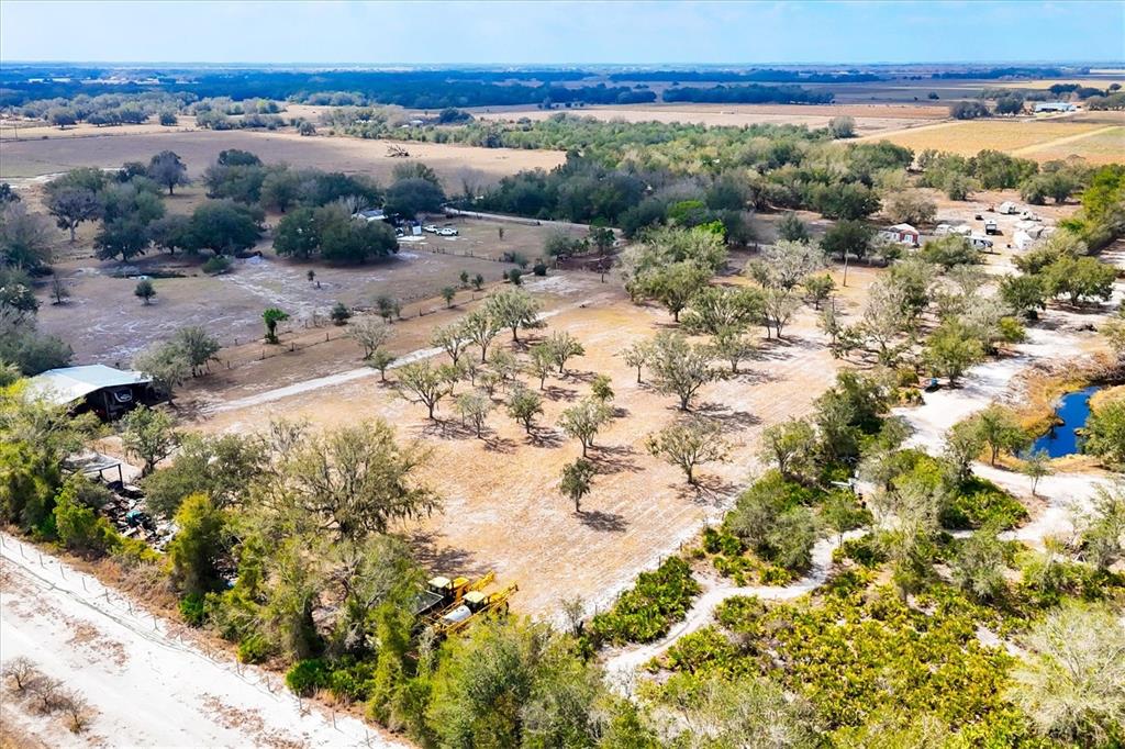 6096 Northwest Cul De Sac Road Arcadia, FL 34266 - Photo 4 of 20 a view of a dry yard with mountains in the background